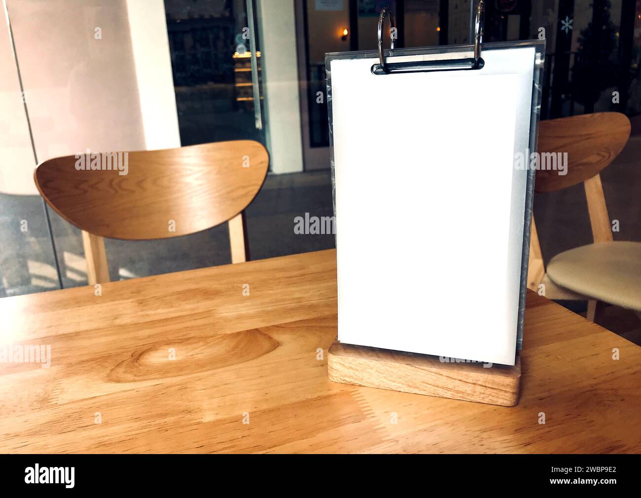 Space on the small standee advertisement on the table in a restaurant, natural sunlight from the window. Stock Photo