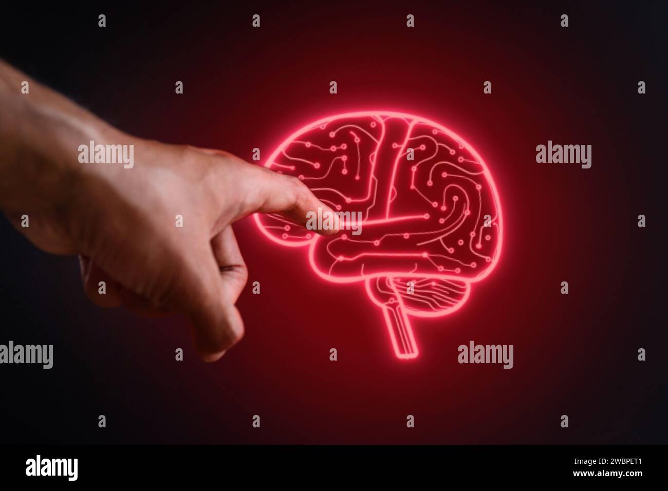Hand and glowing brain shaped circuit board on black background. Artificial intelligence concept. Stock Photo
