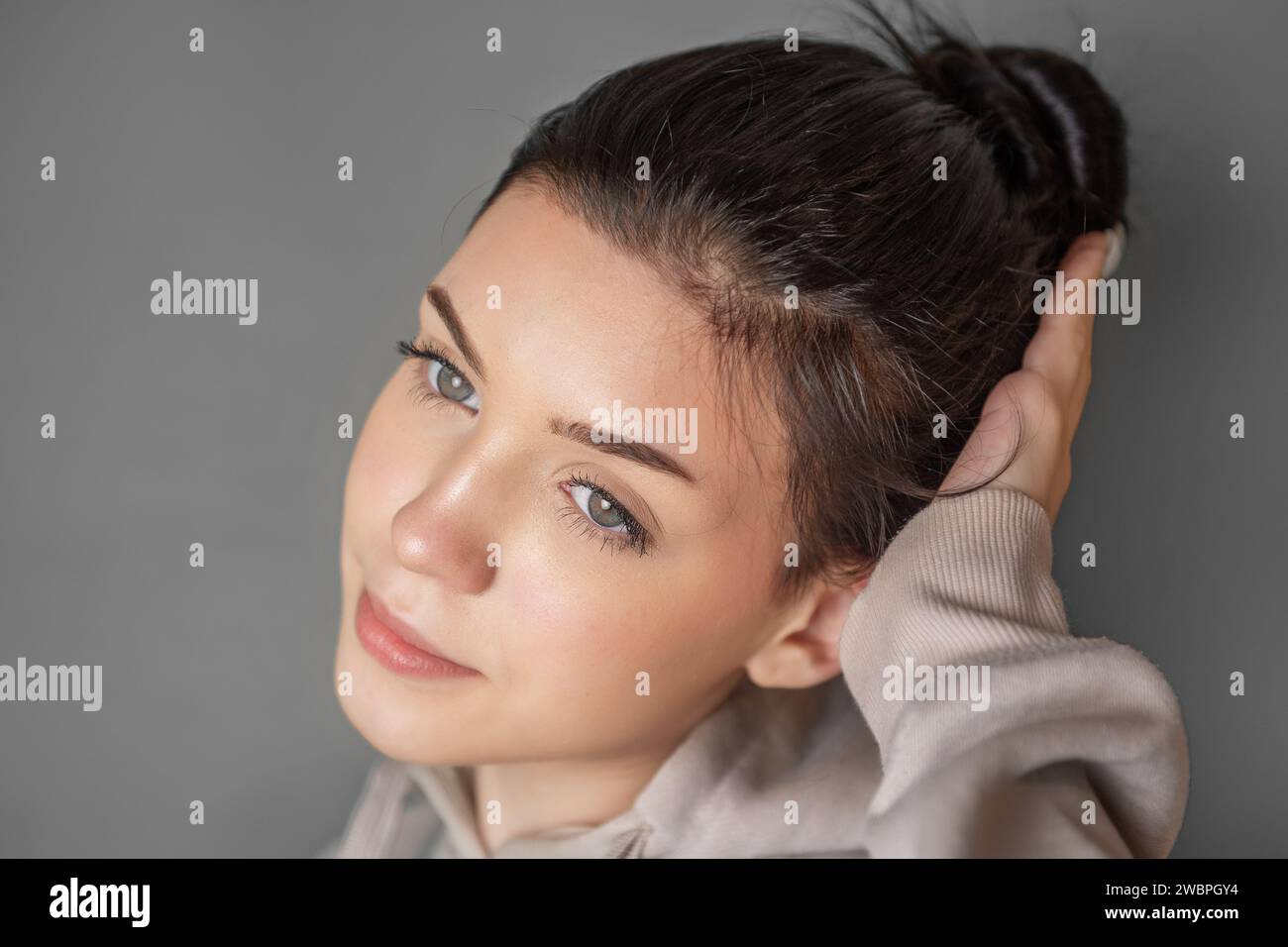 Portrait of a young pretty smoling girl in a  hoodie Stock Photo