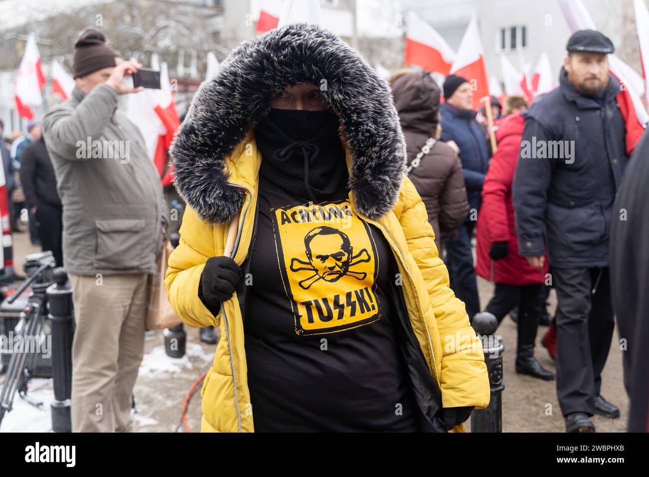 A women wearing sweatshirt with the inscription ACHTUNG WHERE THE LETTERS ARE SHOWN AS THE Emblem of the SS Schutzstaffel at a rally in front of the Polish Parliament in Warsaw, January 11, 2024. Thousands of people gathered in front of the Sejm to protest against the pro-European coalition led by Donald Tusk, demanding the release of PiS PiS MPs Mariusz Kaminski and Maciej Wasik and the return of state media to PiS influence. Warsaw Poland Anti-Governmental Protest In Warsaw 2024/01/11 Copyright: xMarekxAntonixIwanczukx MAI09674 Stock Photo