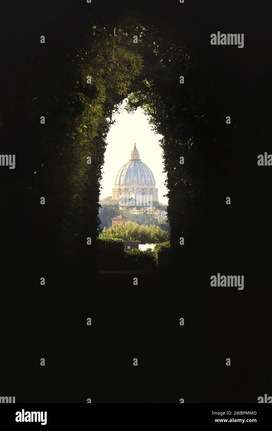 An amazing view of St. Peter's Dome through the Knights of Malta keyhole on the eventide hill in Rome. Stock Photo