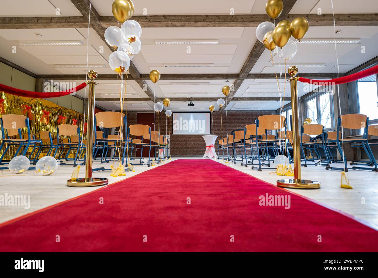 German Abitur Graduation party room decoration with Balloons and Award sculptures red carpet preparations for surprise party Stock Photo