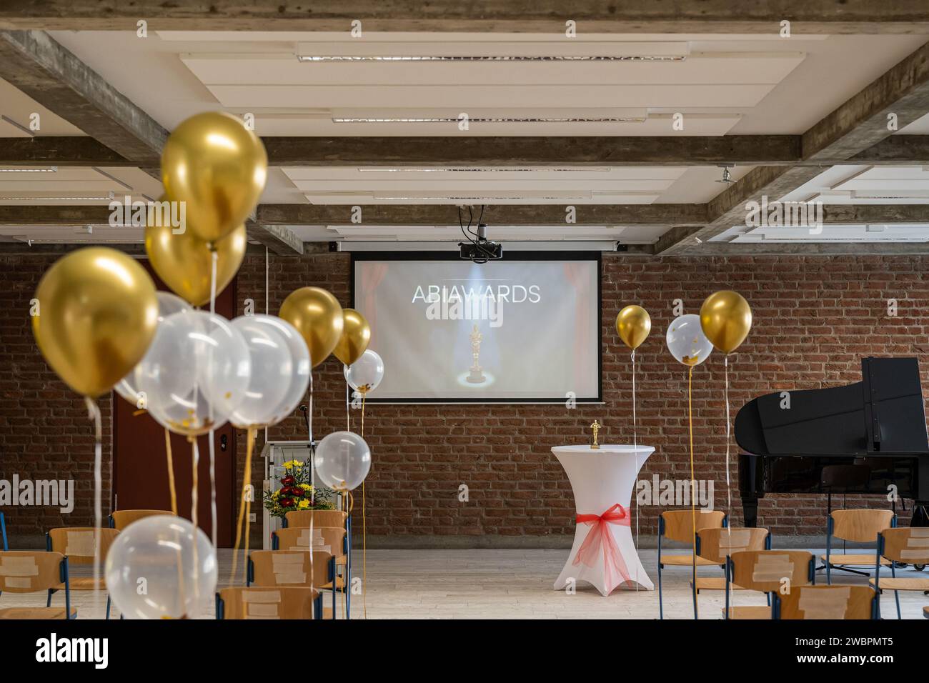 German Abitur Graduation party room decoration with Balloons and Award sculptures red carpet preparations for surprise party Stock Photo