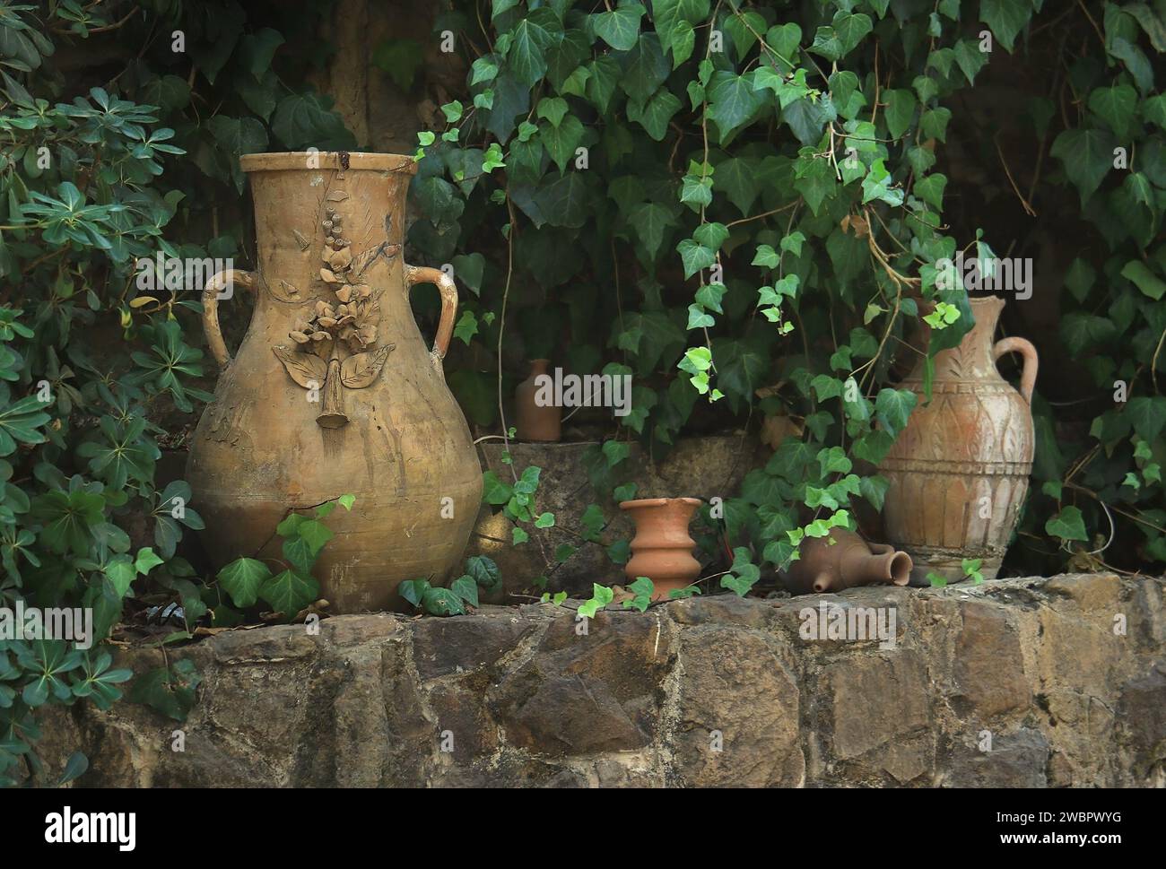Lebanese terracotta jars in a lush green garden. Stock Photo