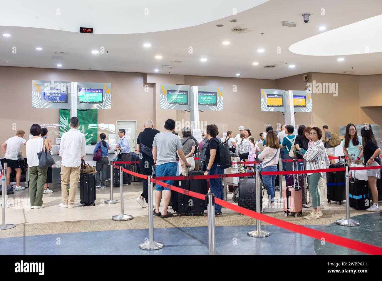 Penang, Malaysia - January 11, 2024: People at the check-in counters at the Penang International Airport. Stock Photo