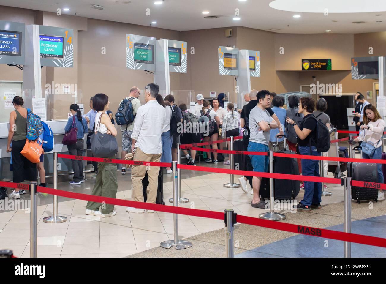 Penang, Malaysia - January 11, 2024: People at the check-in counters at the Penang International Airport. Stock Photo