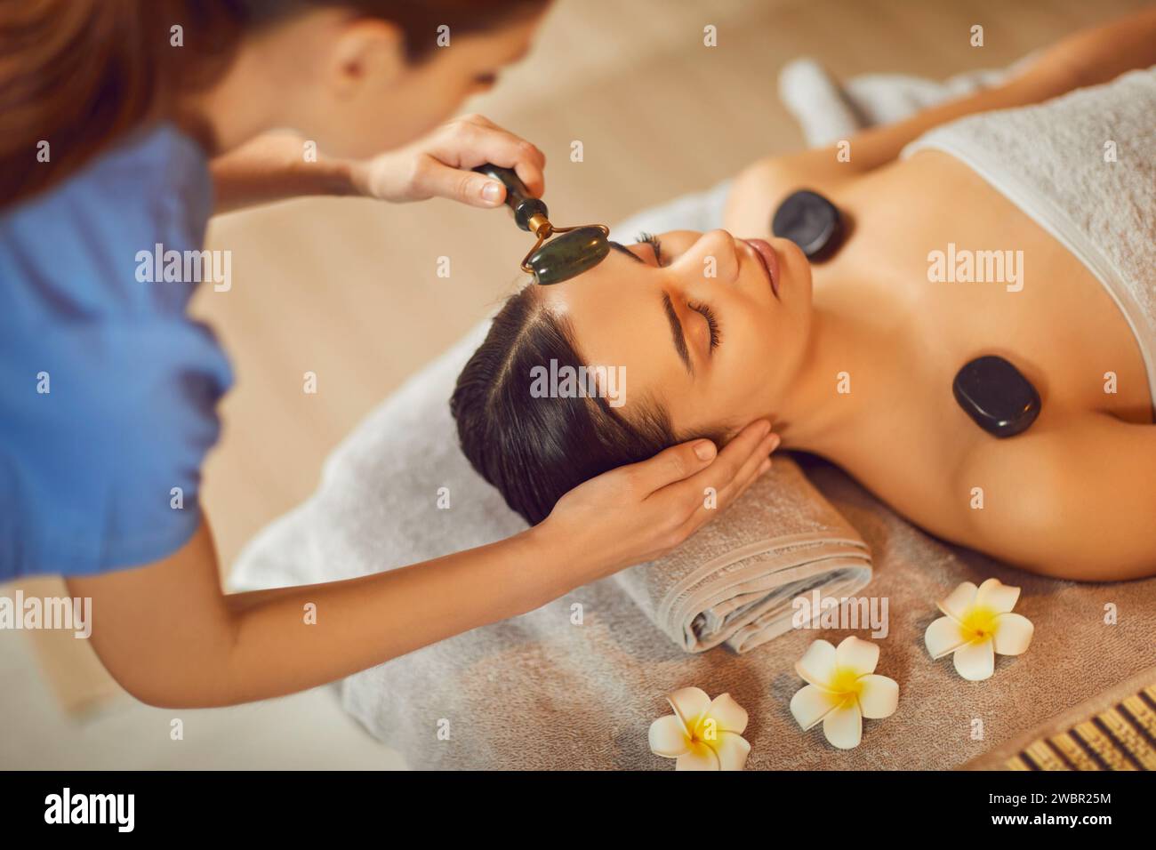 Beautiful young woman relaxing in spa salon, view from above Stock Photo