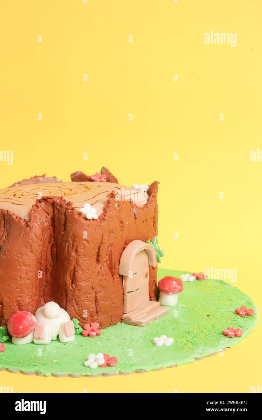 Easter log cake with textured look on the tree trunk and Easter bunny Stock Photo