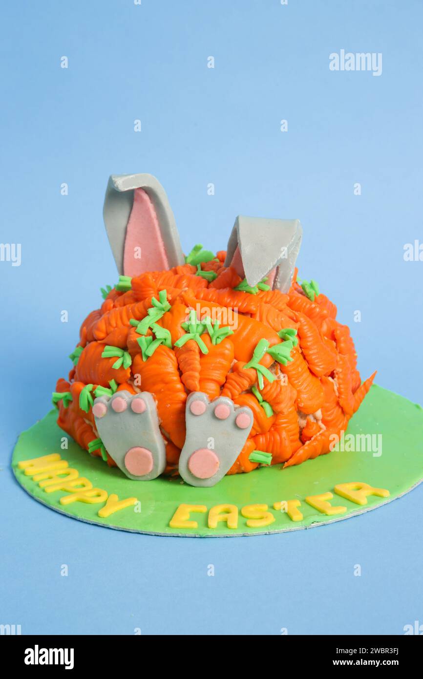 Carrot covered Easter bunny cake, happy Easter concept Stock Photo