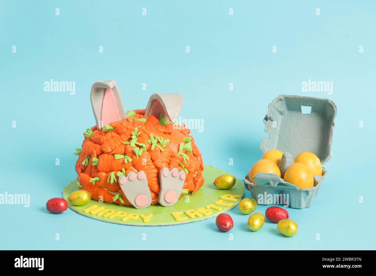 Carrot covered Easter bunny cake, happy Easter concept Stock Photo