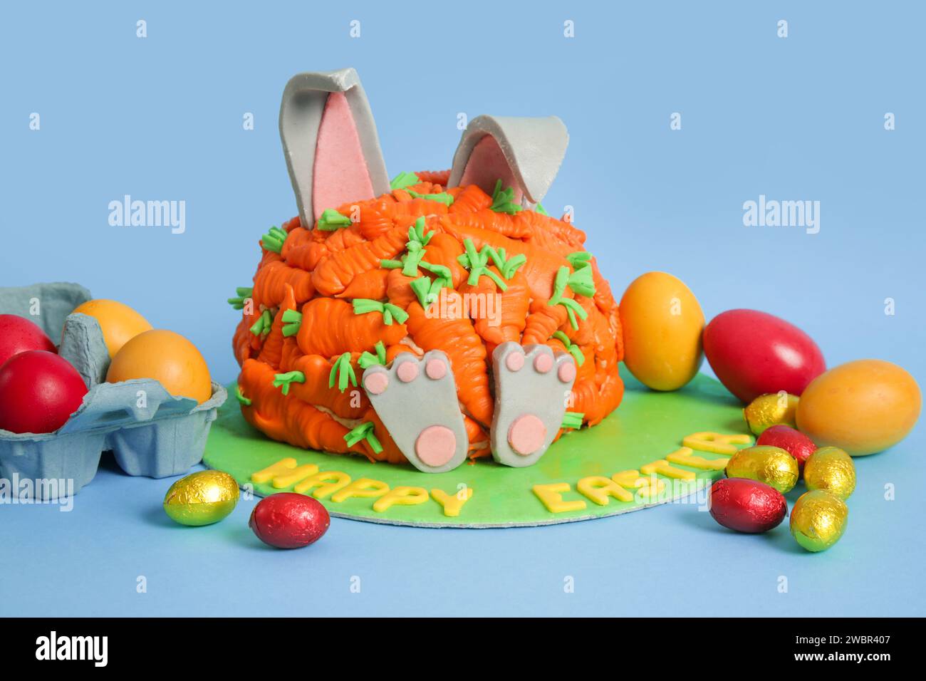 Carrot covered Easter bunny cake, happy Easter concept Stock Photo