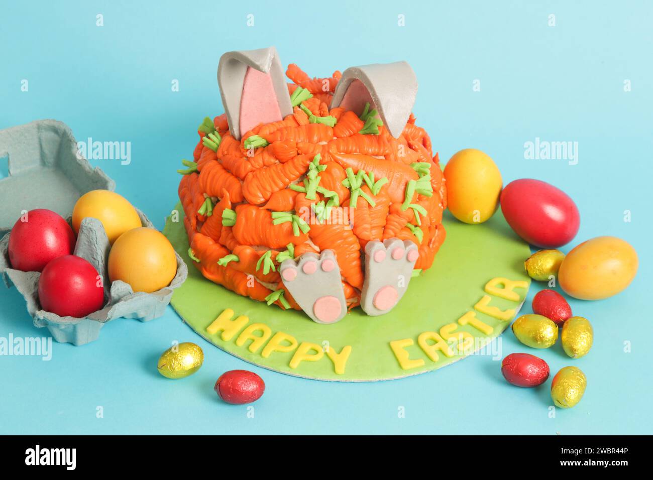 Carrot covered Easter bunny cake, happy Easter concept Stock Photo