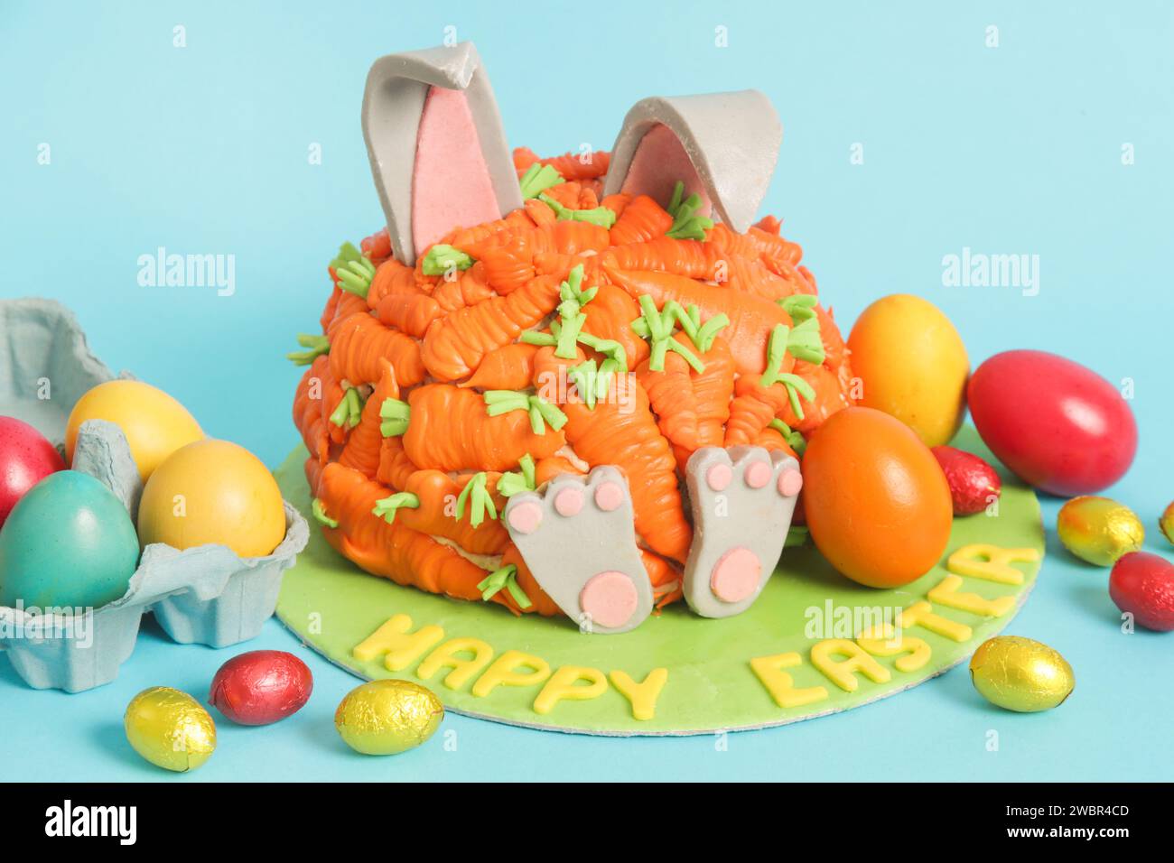 Carrot covered Easter bunny cake, happy Easter concept Stock Photo