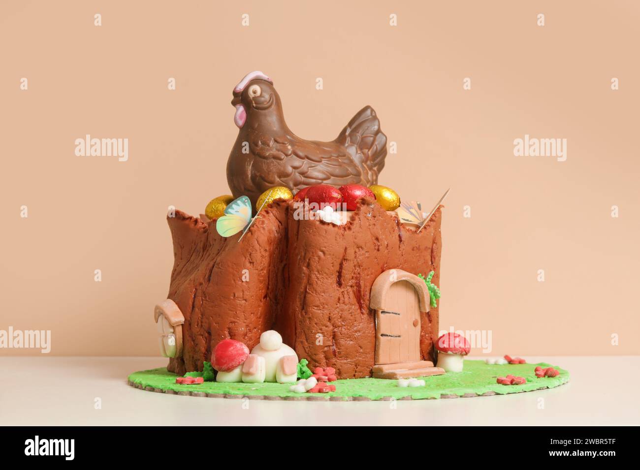 Easter log cake with textured look on the tree trunk and Easter bunny Stock Photo