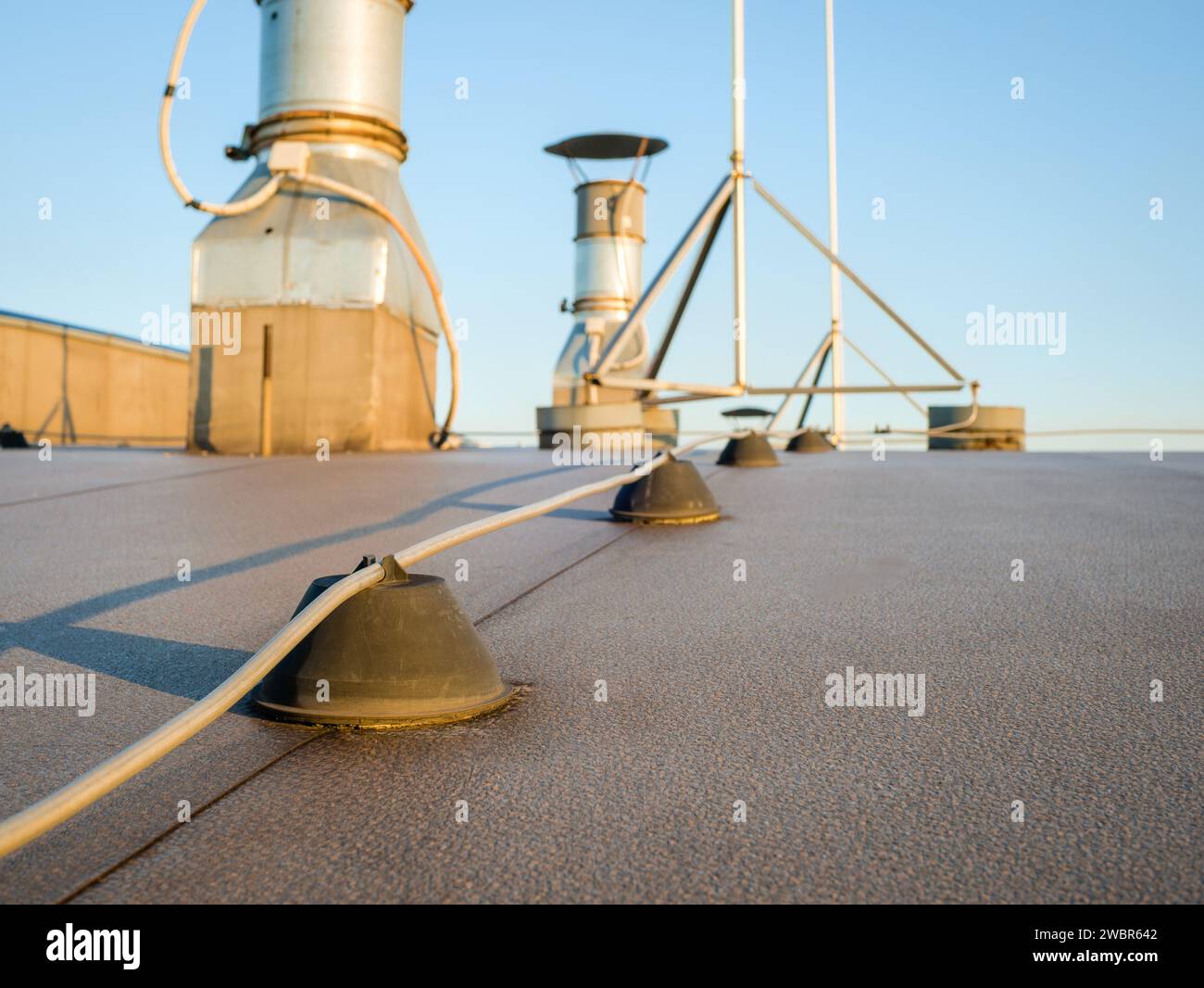 Close-up of a lightning rod and ventilation system on the roof of a building Stock Photo