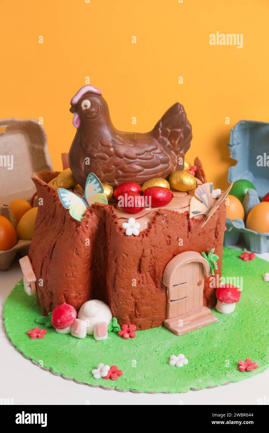 Easter log cake with textured look on the tree trunk and Easter bunny Stock Photo