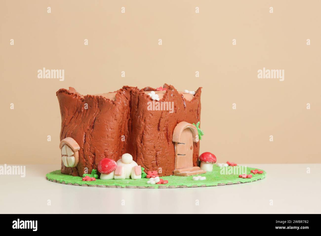 Easter log cake with textured look on the tree trunk and Easter bunny Stock Photo