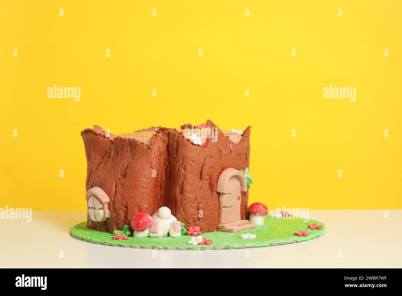 Easter log cake with textured look on the tree trunk and Easter bunny Stock Photo