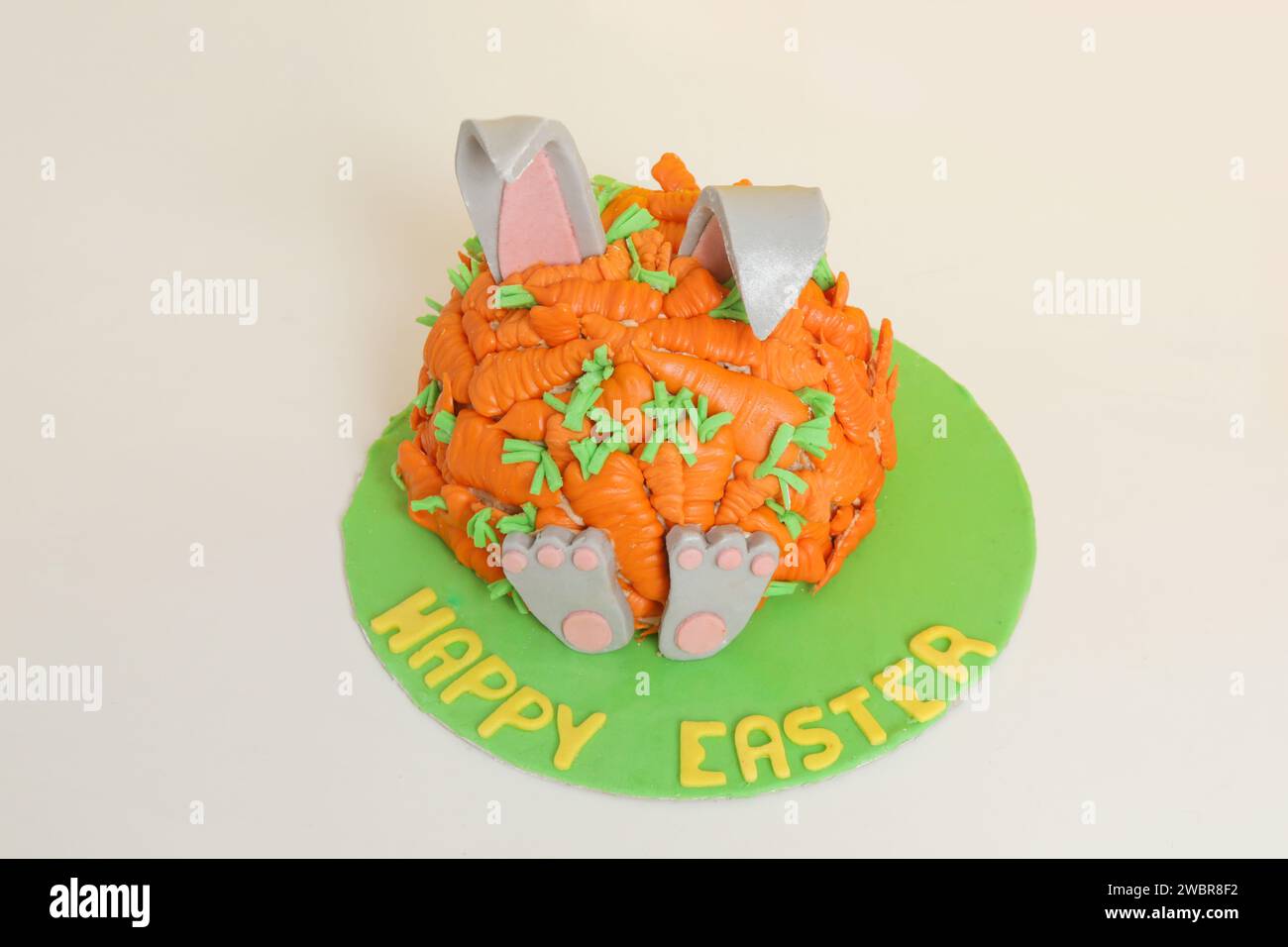 Carrot covered Easter bunny cake, happy Easter concept Stock Photo