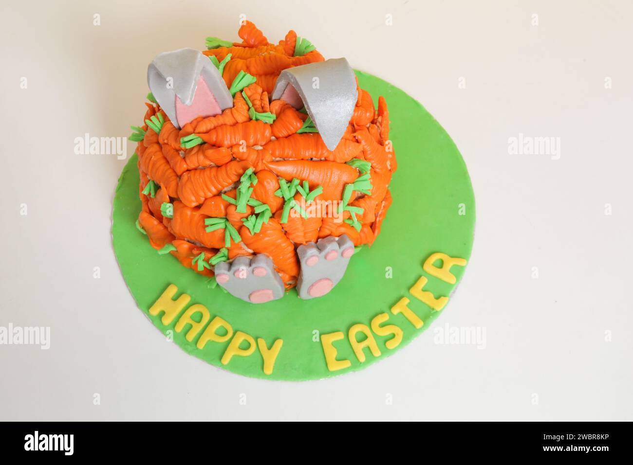 Carrot covered Easter bunny cake, happy Easter concept Stock Photo