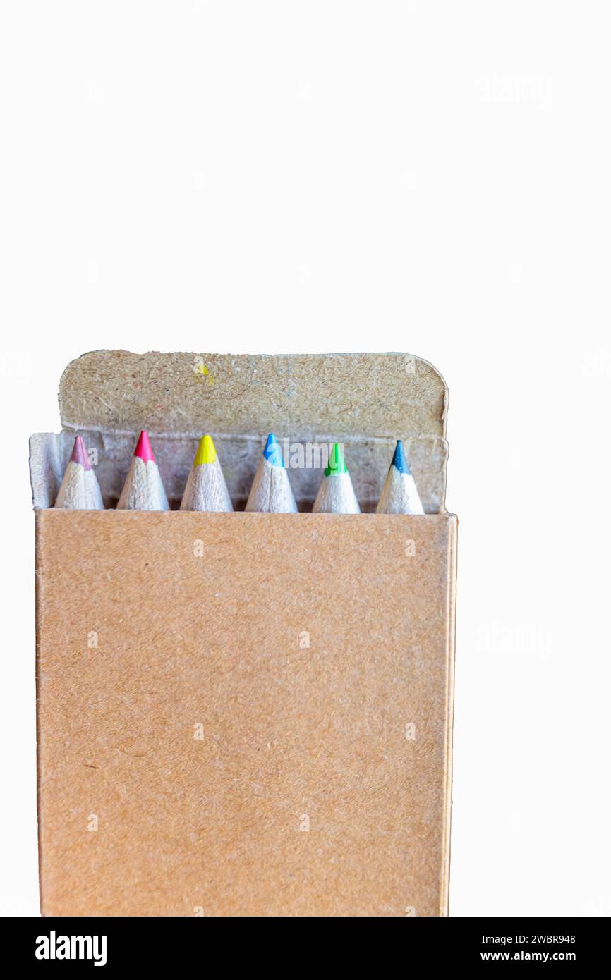 five colored pencils in a carton box on a white background Stock Photo