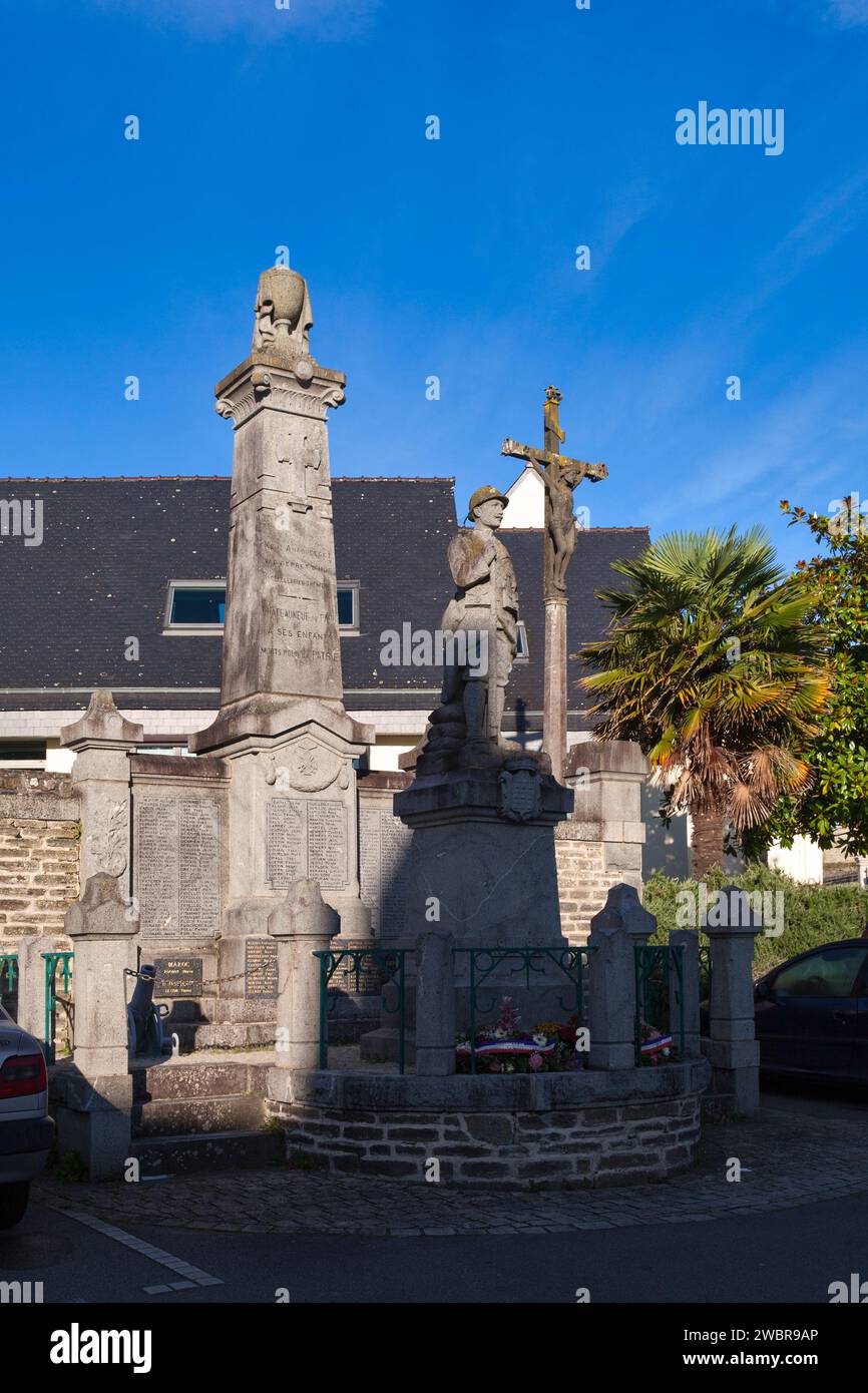 Châteauneuf-du-Faou, France - October 09 2021: War memorial located Place Saint-Michel next to a Calvary cross. Stock Photo