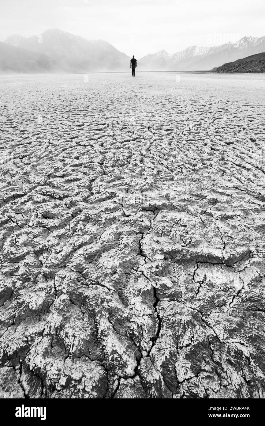 Lone man in barren, dry landscape in Yukon Territory, Canada Stock Photo