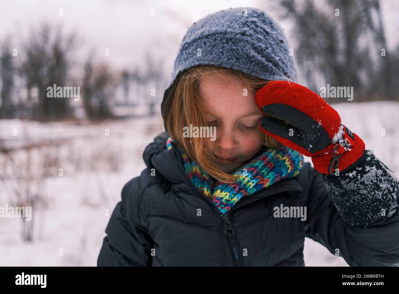Young child in winter clothing with hat, scarf, and gloves Stock Photo
