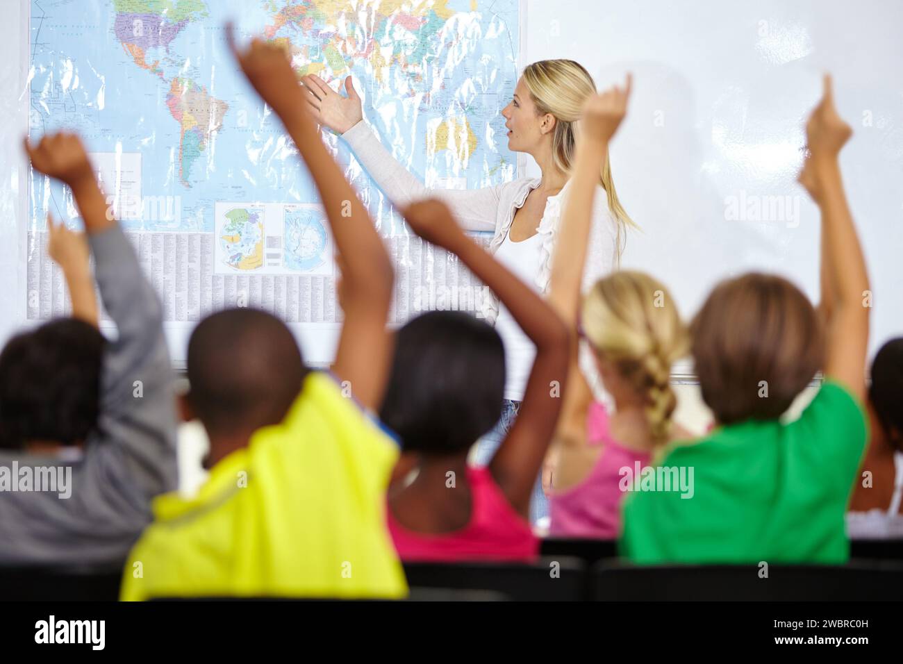 Back of students, teacher and raise hands for questions, education or