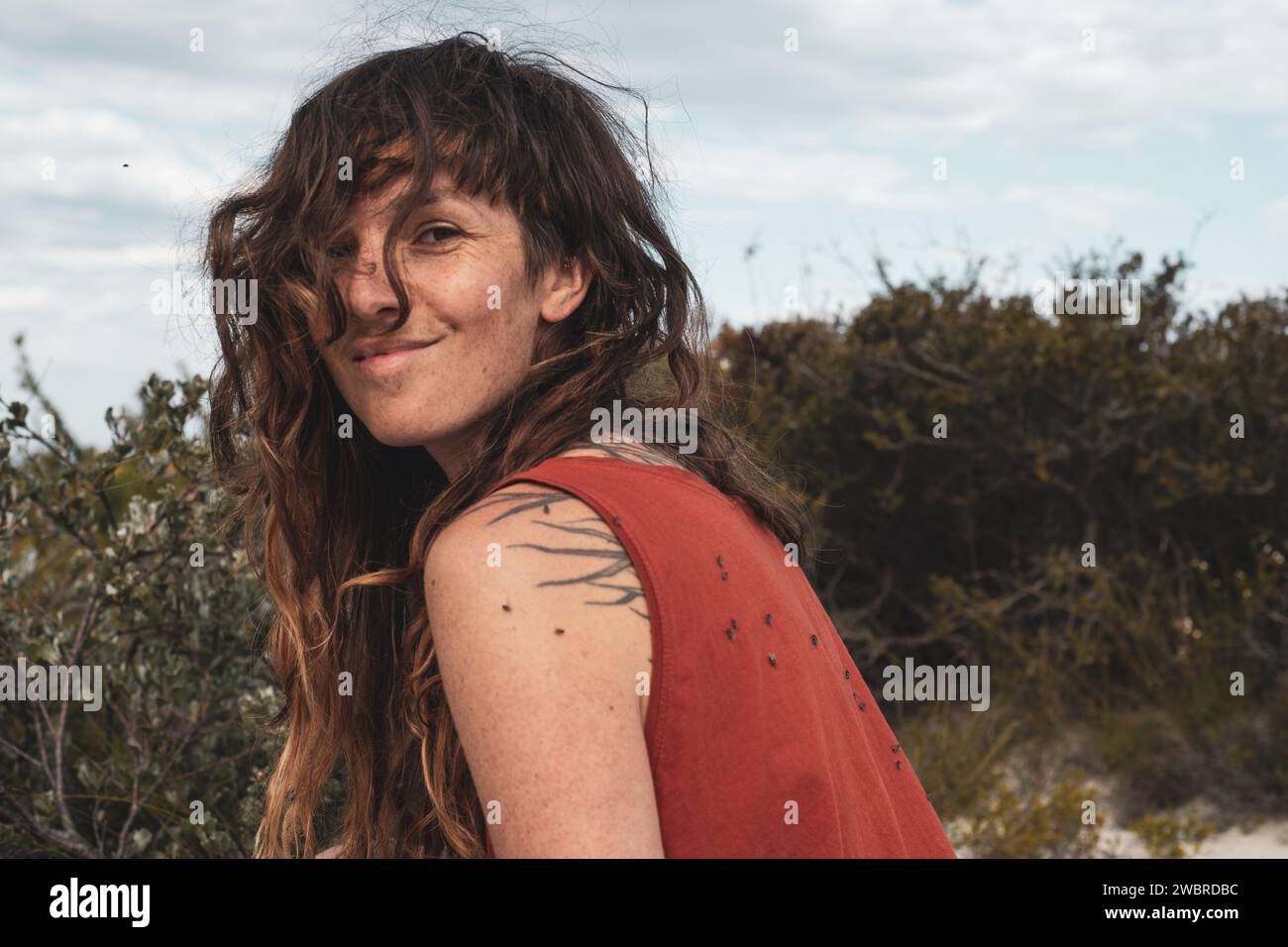 portrait of happy woman on hike with flies smiling Stock Photo