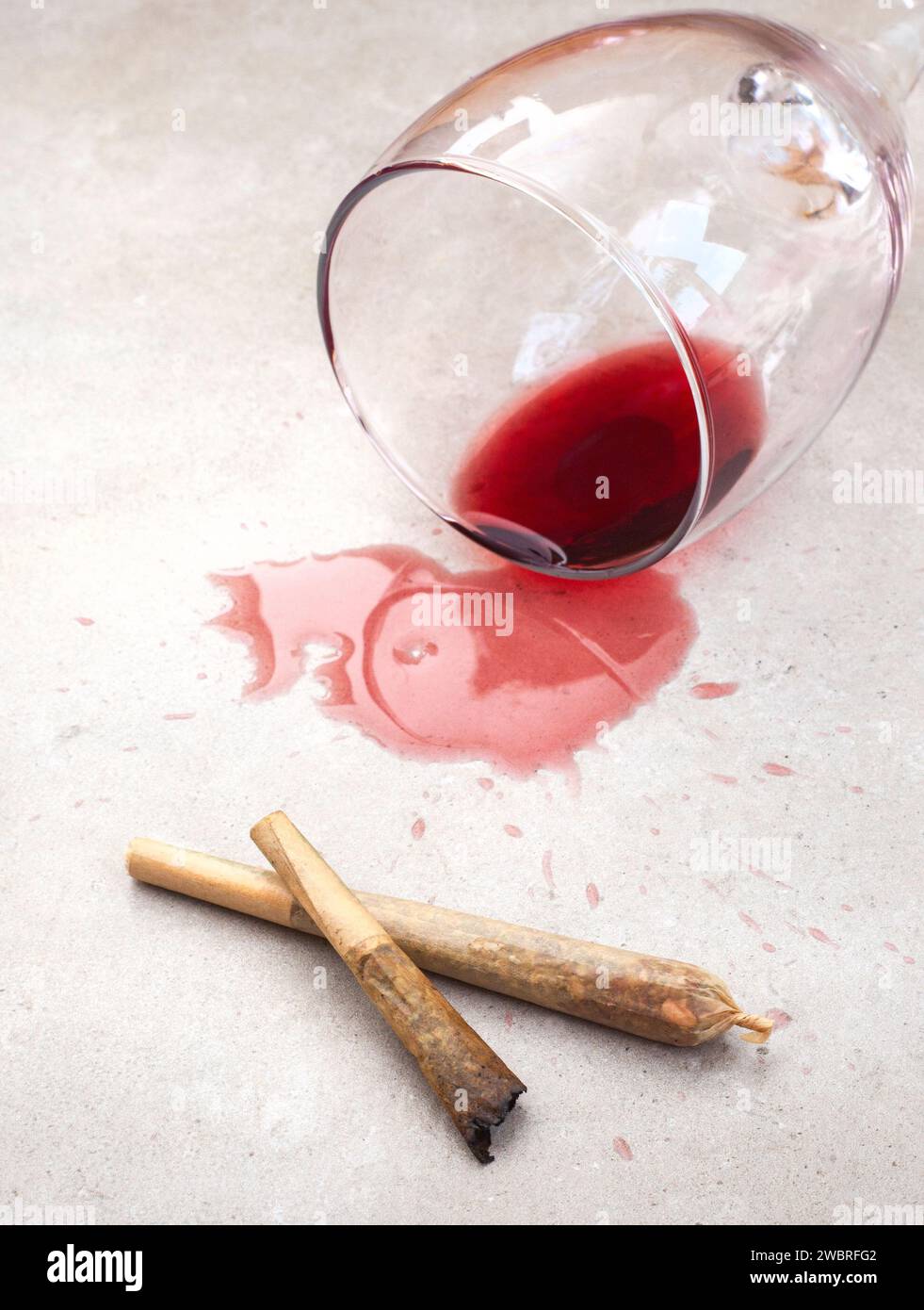 Marijuana joint with spilled red wine Stock Photo Alamy