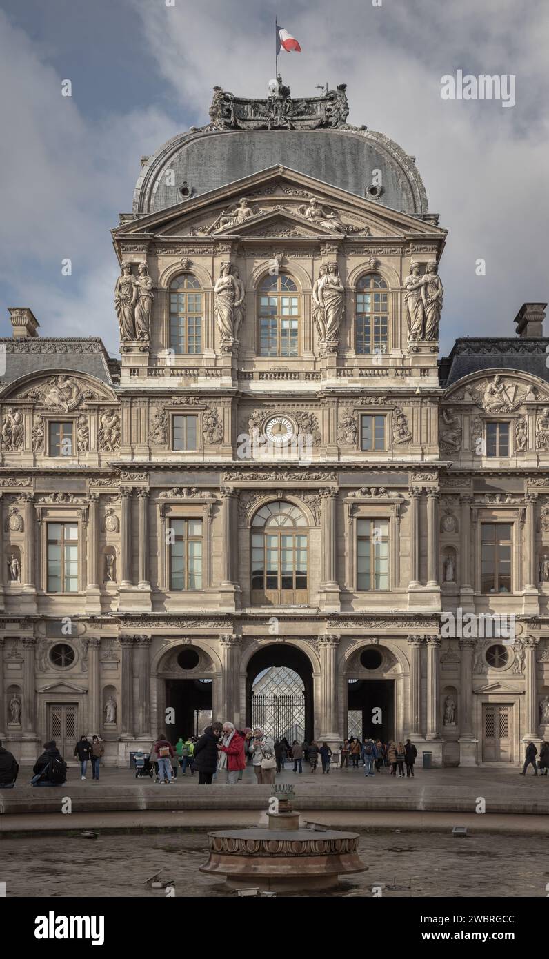 France, Paris - Jan 03, 2024 - Exterior of Palais du Louvre (Pavillon de l'Horloge) or The Louvre Palace. West facade of the sully wing, is a magnific Stock Photo