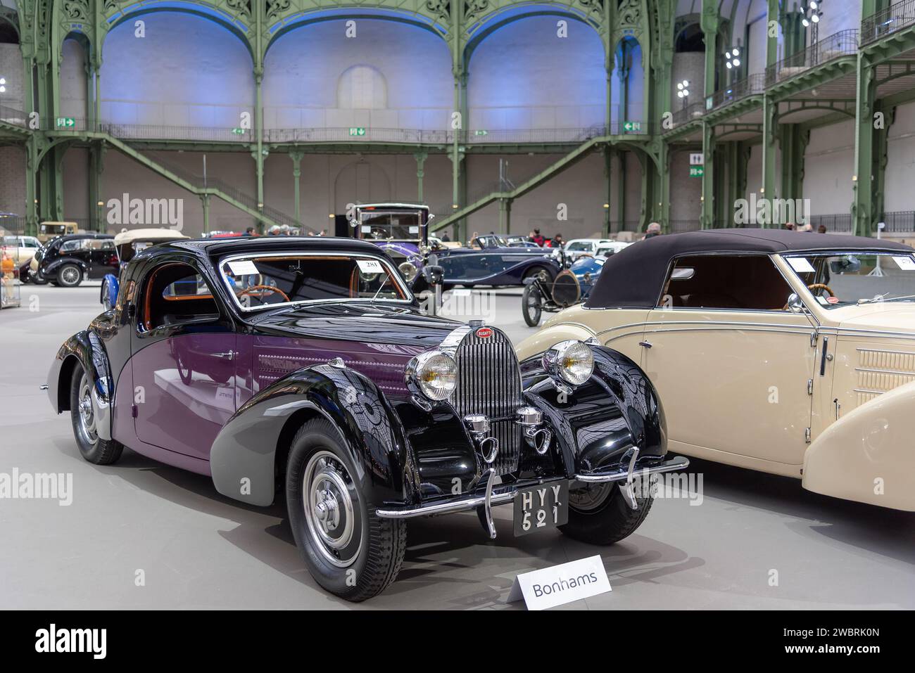 Paris, France - Bonhams 2020 sale at the Grand Palais in Paris. Focus on a black and purple 1938 Bugatti Type 57 Atalante Coupé. Chassis no. 57633. Stock Photo