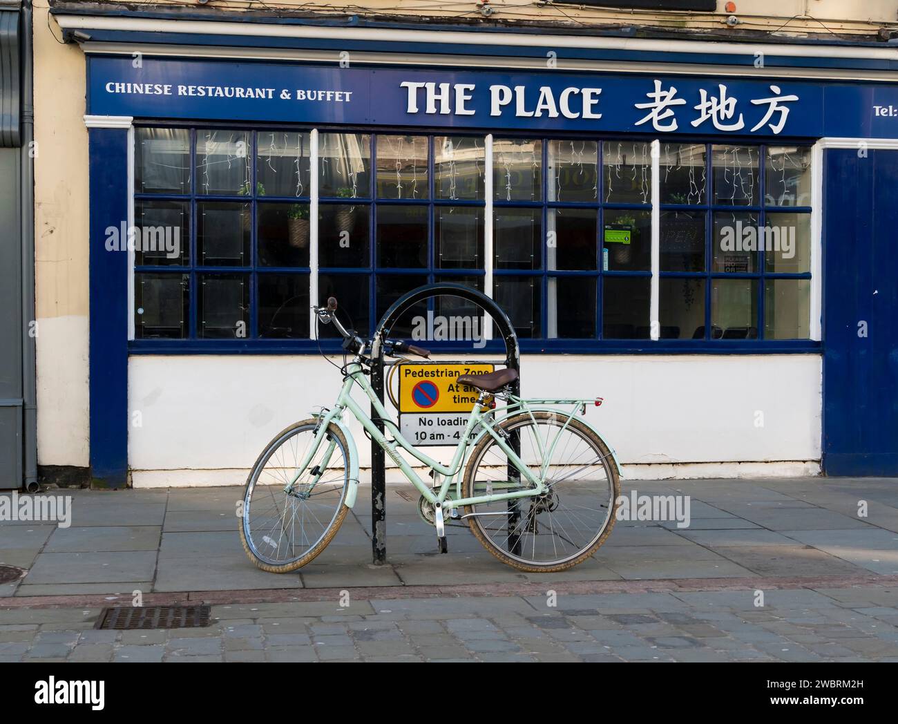 Pale green Pendleton bicycle parked outside The Place Chinese Restaurant, High Street, Lincoln City, Lincolnshire, England, UK Stock Photo