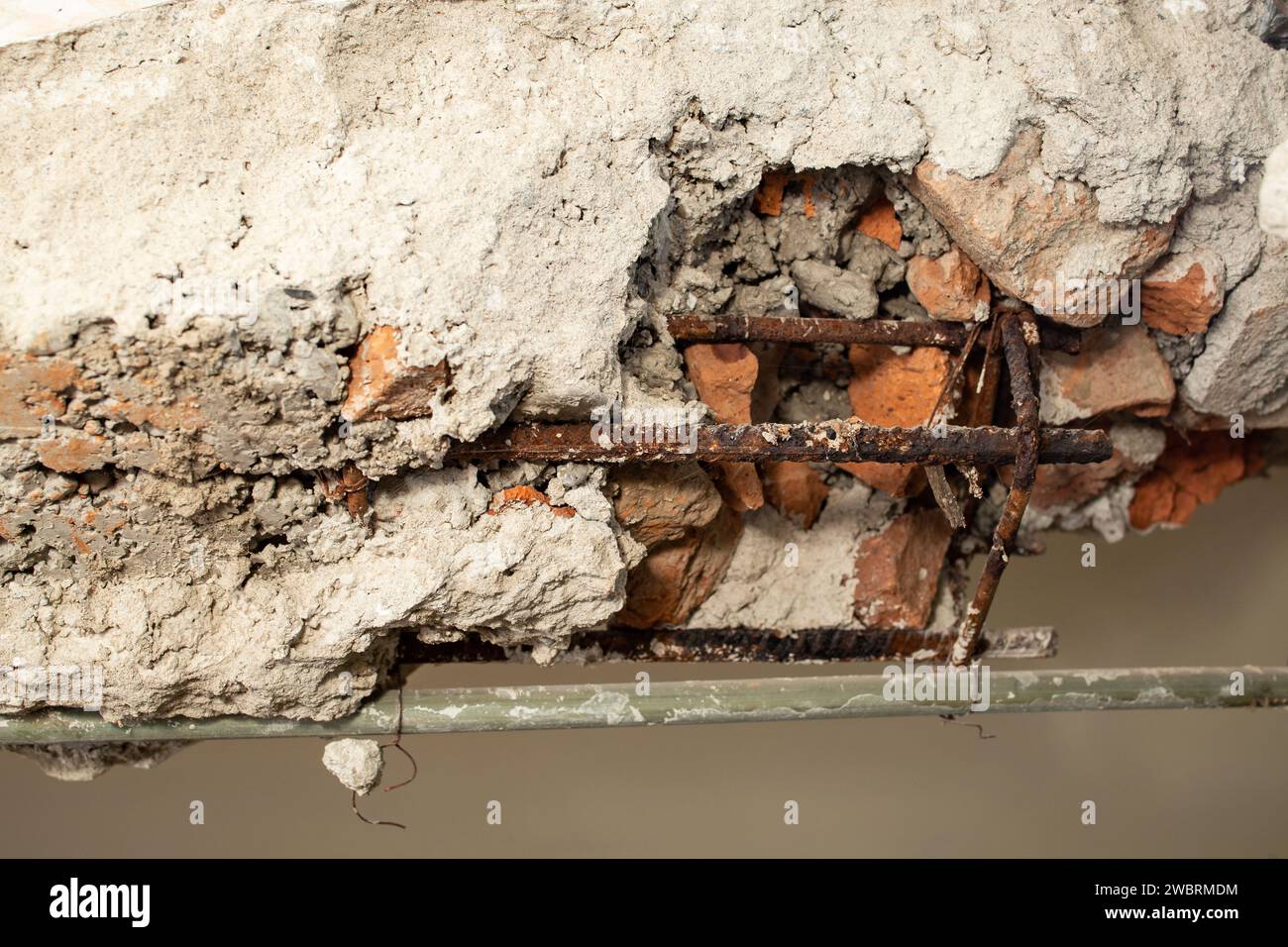 Demolition of a brick wall with iron rods rusted , abstract textures