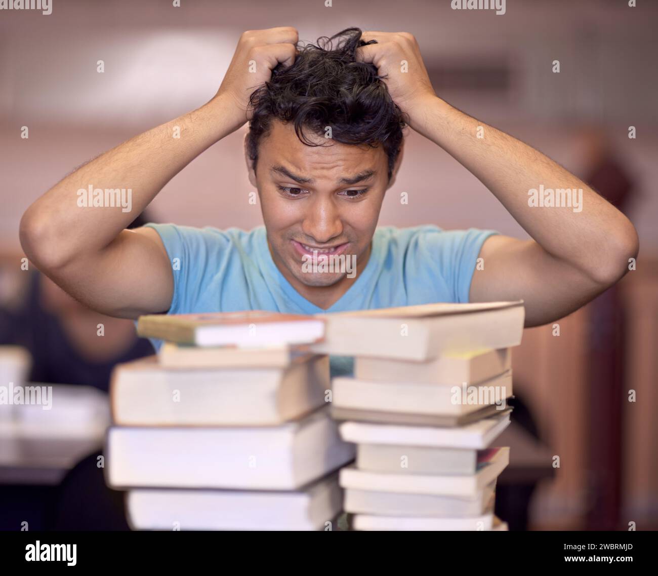 Student man, stress and stack of books for education, development and pulling hair at college