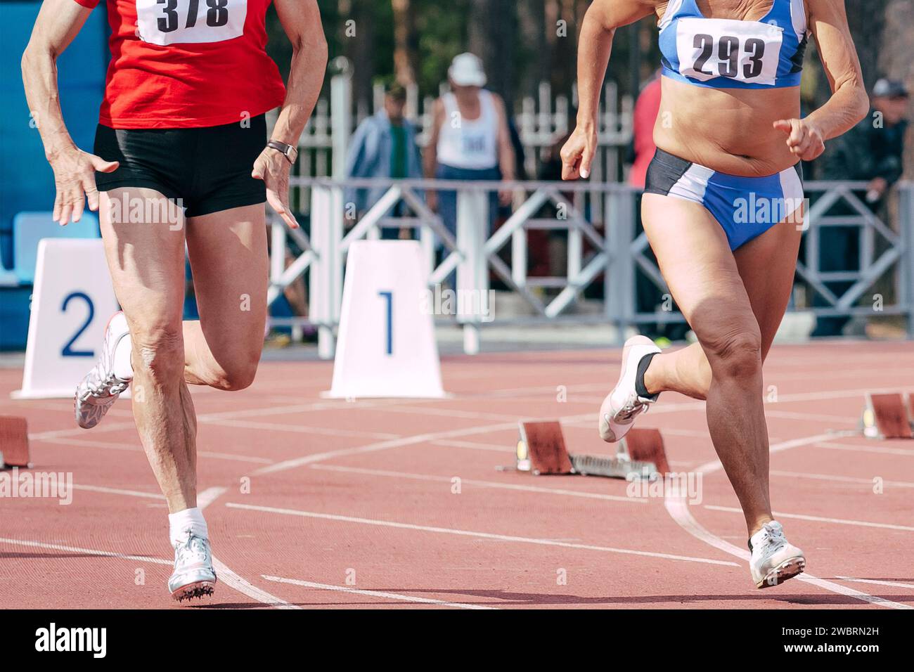 woman runners athletes 50 years old running race in masters athletics summer competition Stock Photo