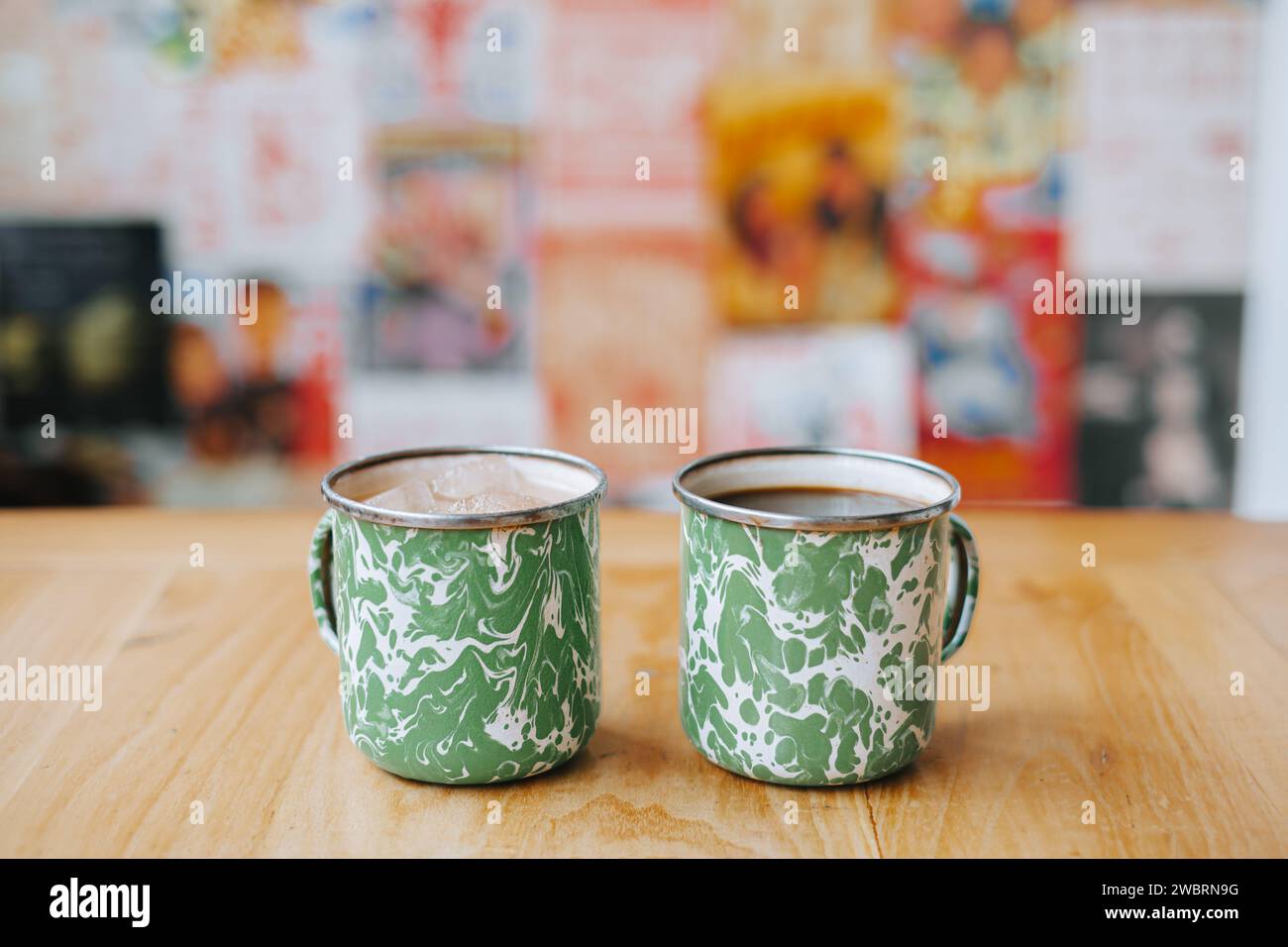 Coffee on vintage Indonesian steel mug with random green pattern called Blirik cup or cangkir Blirik on bokeh background Stock Photo
