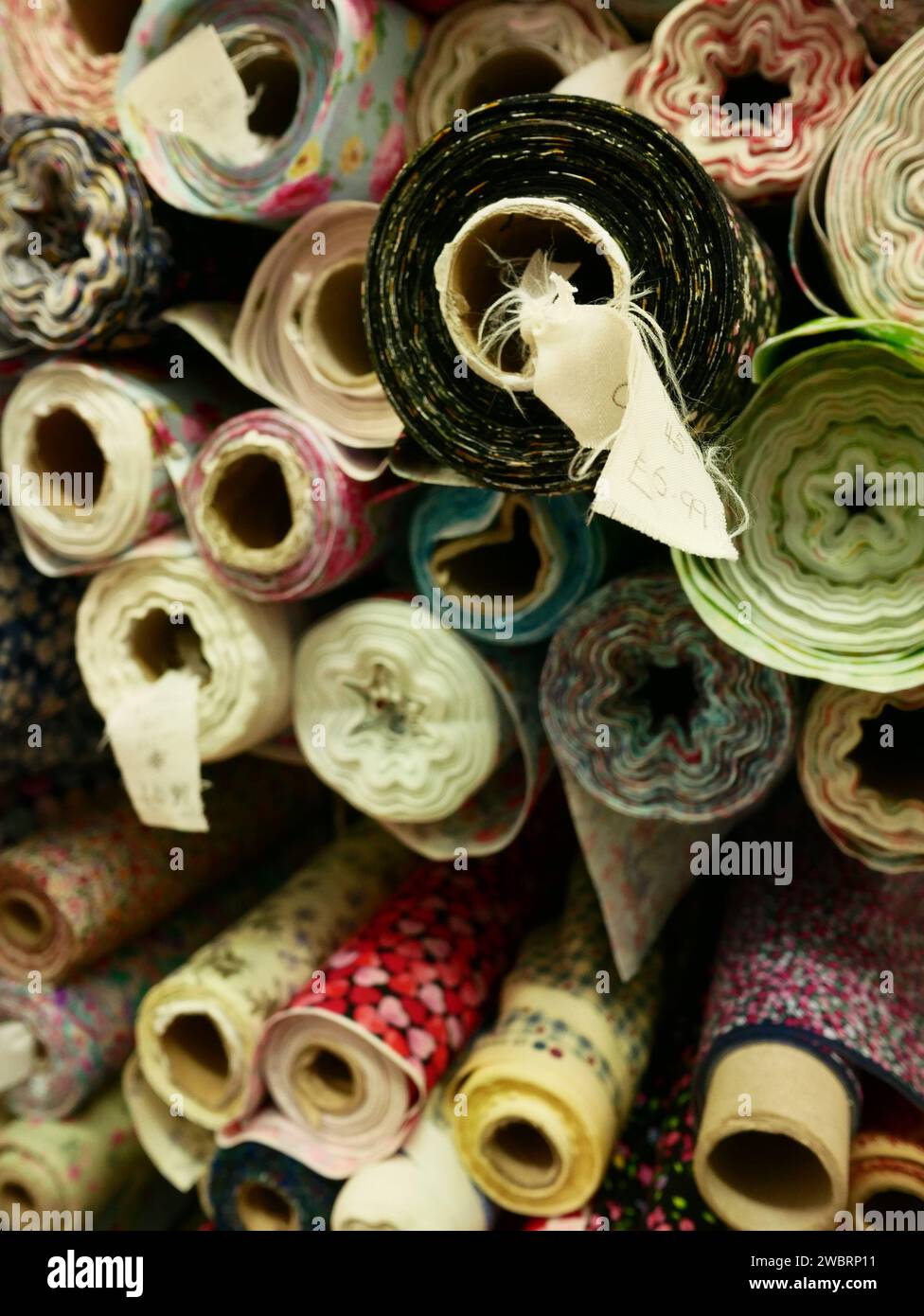 Fabric rolls in a shop for sewing fabric and materials. Stock Photo