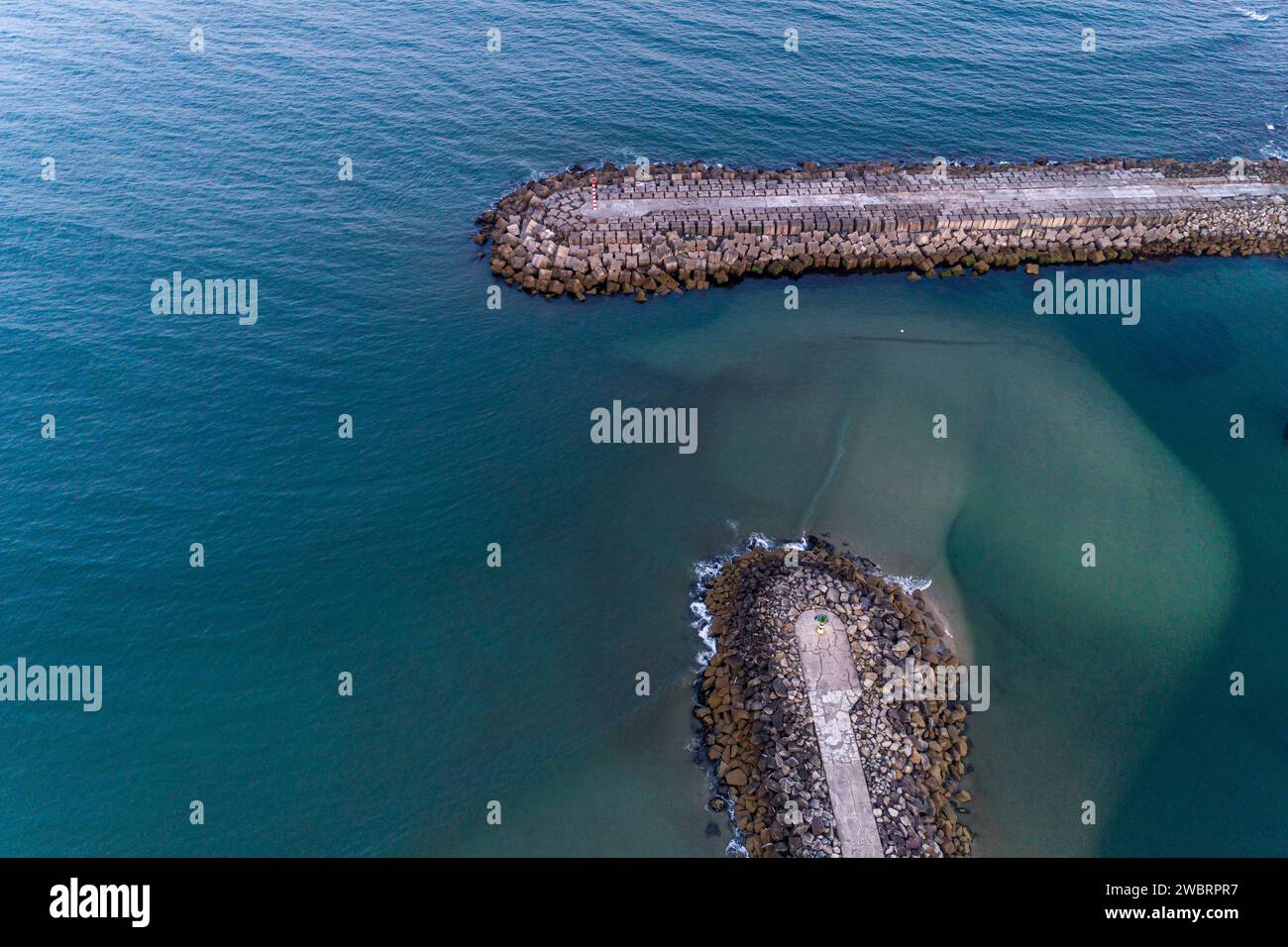 drone aerial view of a concrete block breakwater. Vila Praia de Ancora, Portugal Stock Photo