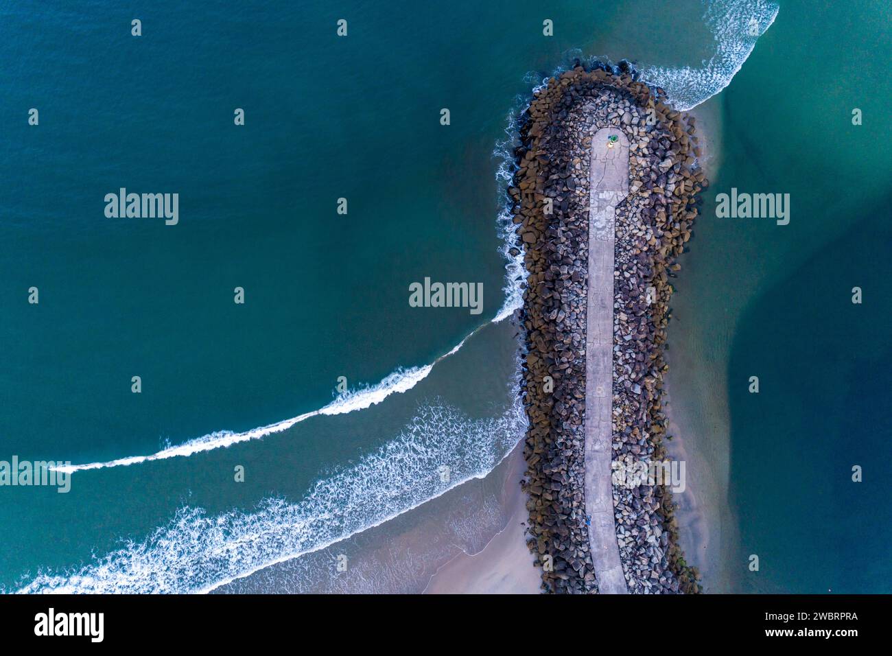 overhead drone aerial view of a concrete block breakwater. Vila Praia de Ancora, Portugal Stock Photo