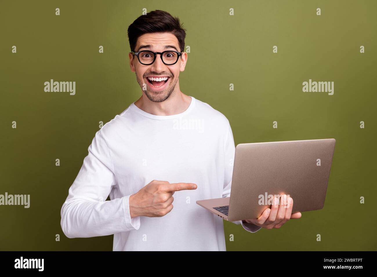 Reading Computer Amazed Portrait of young man amazed technologies reviewer reporter direct ...