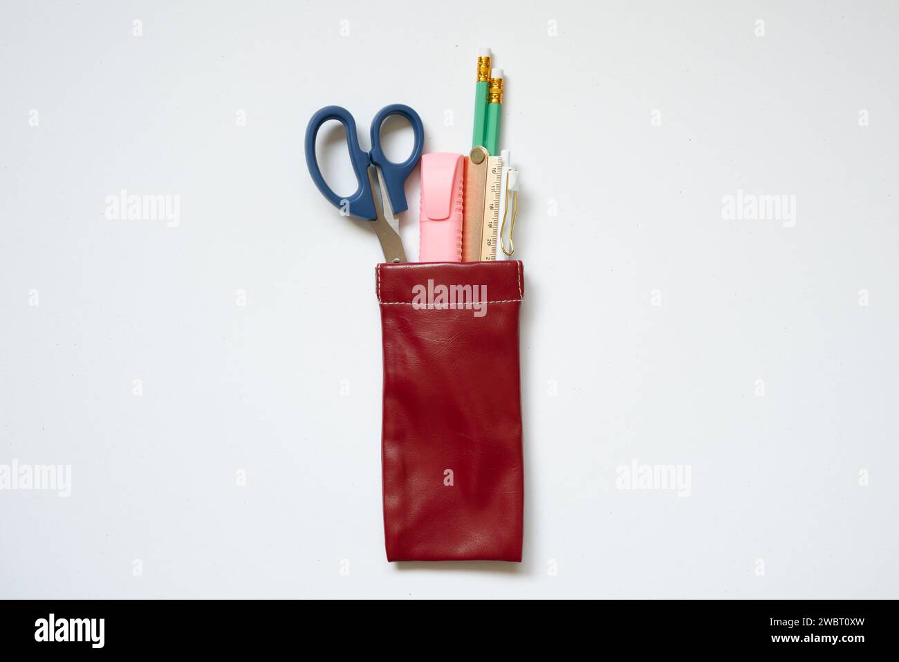 Writing supply. Pencil, pen, ruler, highlighter, scissors in pencil case isolated on white desk background. top view Stock Photo
