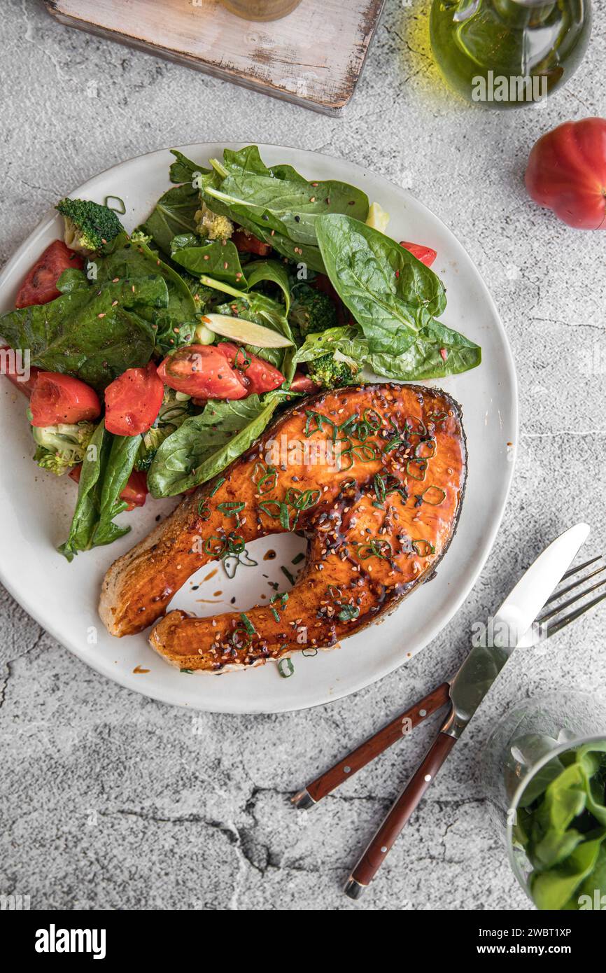 Portion of grilled salmon steak with vegetables Stock Photo - Alamy