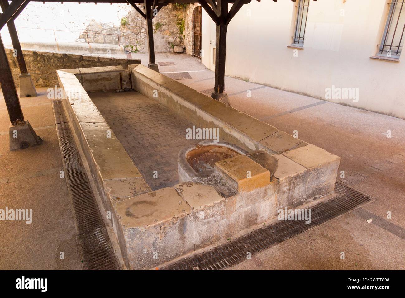 Communal public Lavoir, a stone sink trough to aid water hygiene. Old town Antibes, where people would have washed their laundry washing. France. (135) Stock Photo