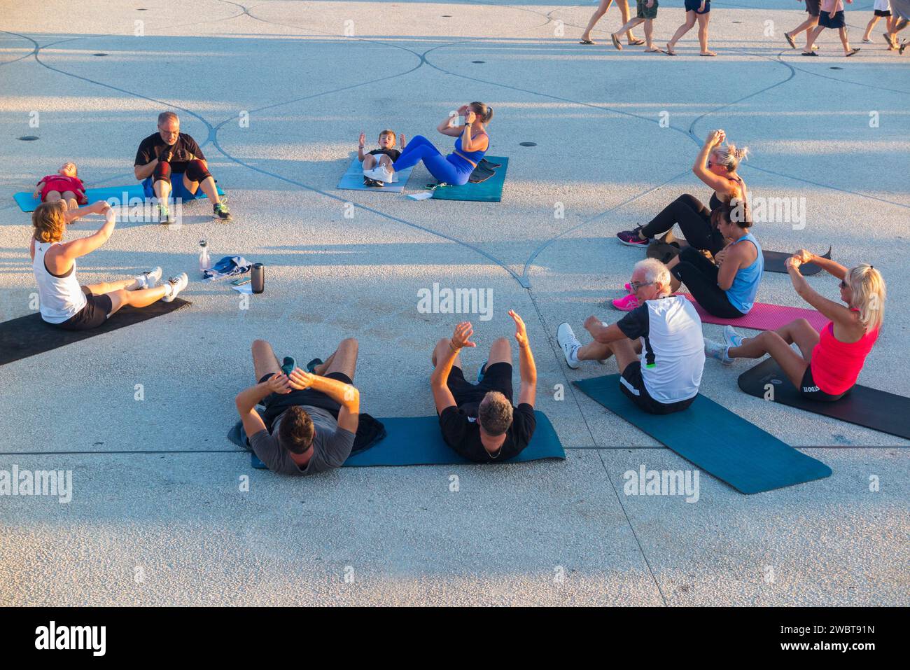 Group of people doing stretching exercises. – Johnson Fitness and Wellness