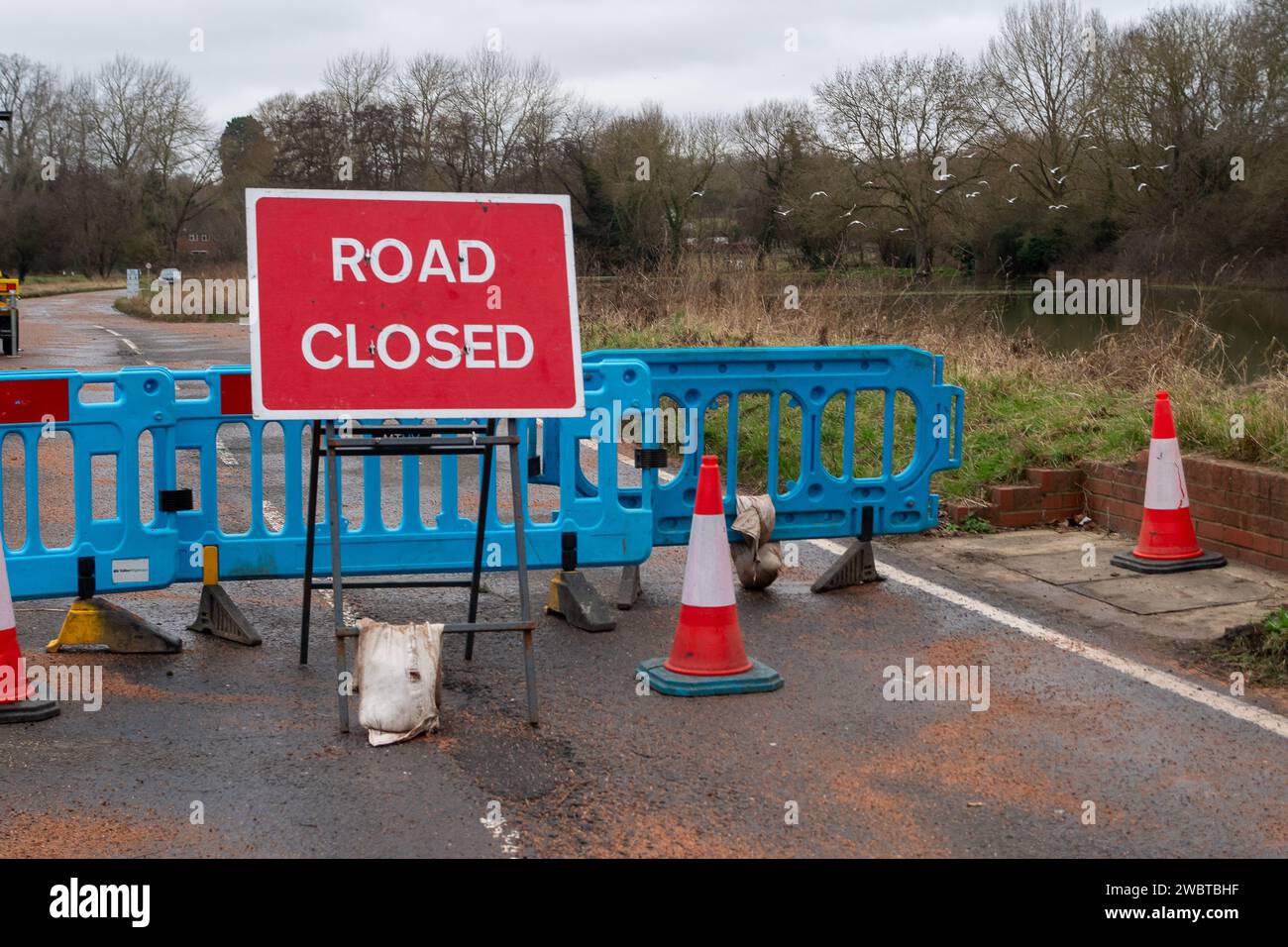 Cookham, UK. 6th January, 2024. The B4447 main road through Cookham Moor in the village of Cookham, Berkshire remains closed due to flooding from the River Thames. The old road next to it called the Causeway is open for set hours to allow a limited number of vehicles to cross the bridge there. Credit: Maureen McLean/Alamy Live News Stock Photo