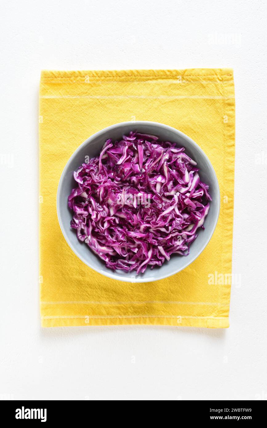 Red cabbage in bowl over white background. Vegetarian vegan or low calories food concept. Top view, flat lay Stock Photo