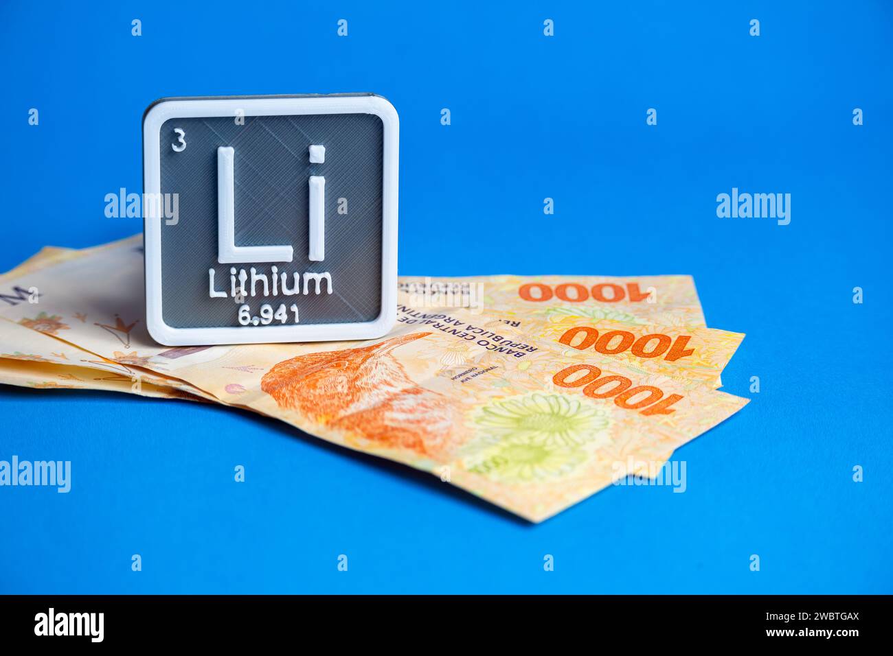 Thousand Argentine peso bills with lithium symbol logo. Stock Photo