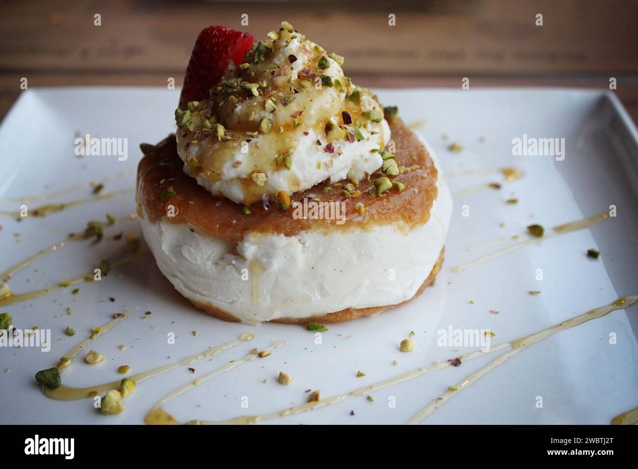 A Lebanese dessert made of ashta and vanilla ice cream with pistachios and drizzled with honey. Stock Photo